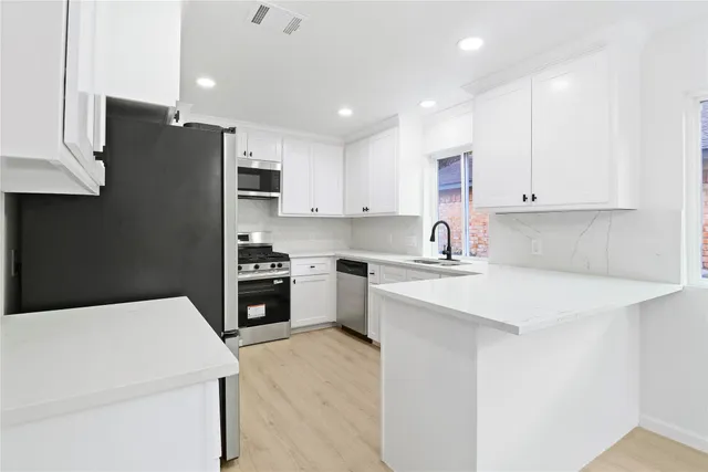 a kitchen with a white stove top oven and refrigerator