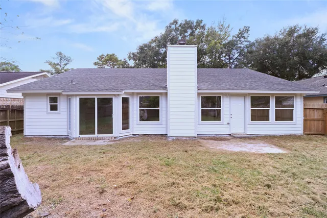 a front view of a house with a garden and yard