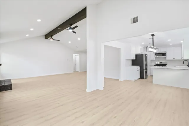 a view of large kitchen with stainless steel appliances