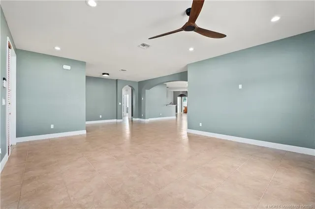 a view of a livingroom with a chandelier wooden floor and a chandelier