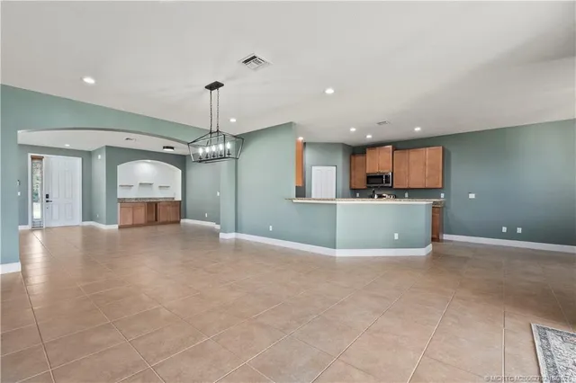 a spacious bathroom with a double vanity sink double mirror and bathtub