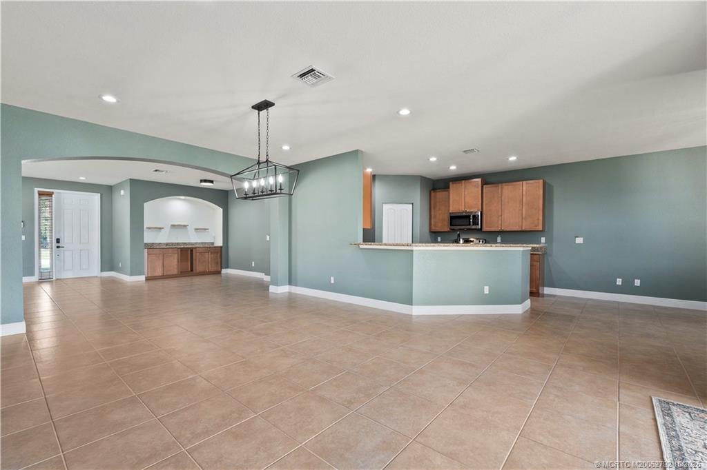 1455 Southeast Conference Circle Stuart, FL 34997 - Photo 18 of 69 a view of a kitchen with a sink and a microwave