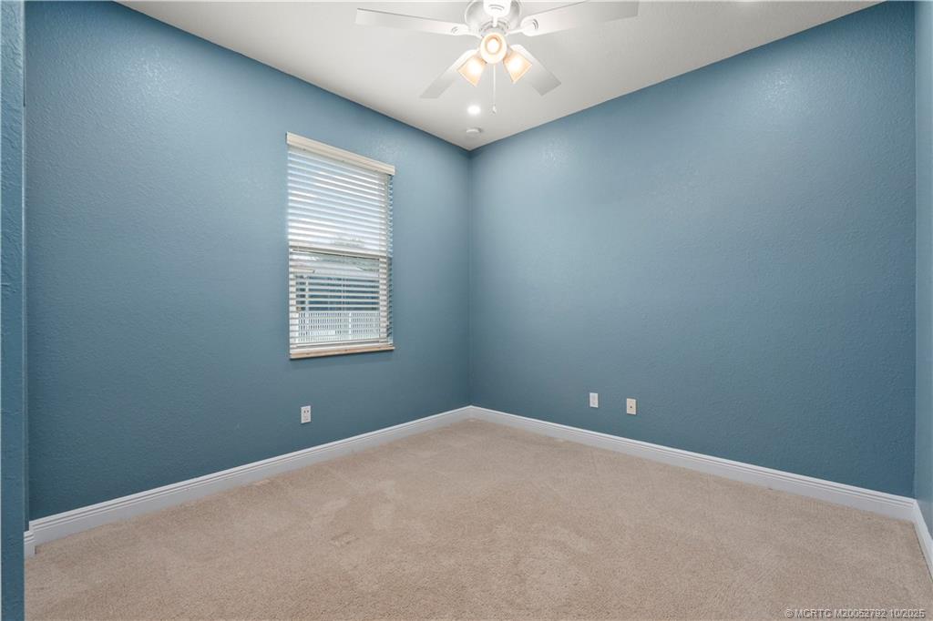 1455 Southeast Conference Circle Stuart, FL 34997 - Photo 34 of 69 an empty room with windows and fan