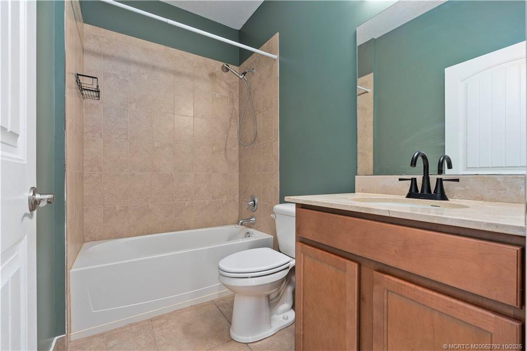 1455 Southeast Conference Circle Stuart, FL 34997 - Photo 36 of 69 a bathroom with a sink a toilet and shower