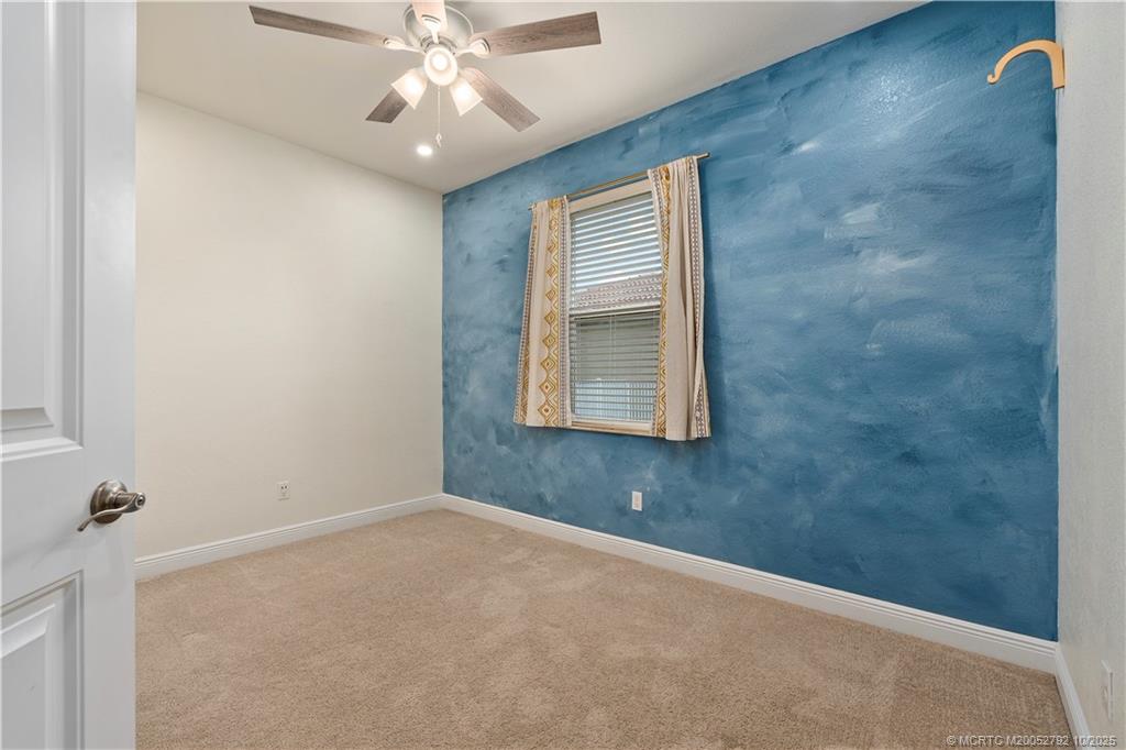 1455 Southeast Conference Circle Stuart, FL 34997 - Photo 38 of 69 an empty room with windows and fan