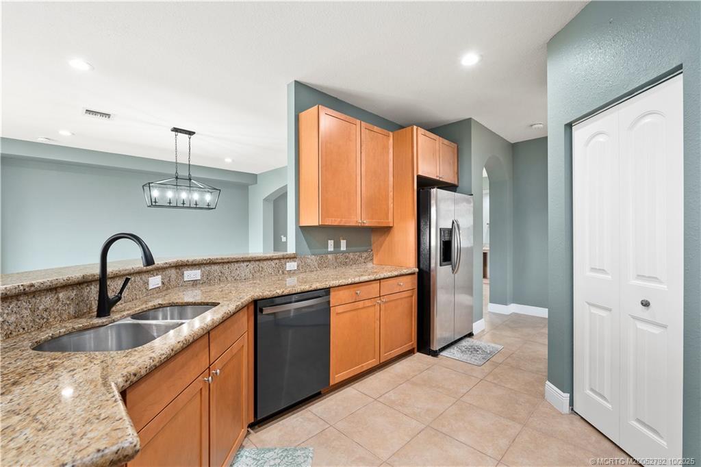 1455 Southeast Conference Circle Stuart, FL 34997 - Photo 9 of 69 a kitchen with stainless steel appliances granite countertop a sink a stove and refrigerator