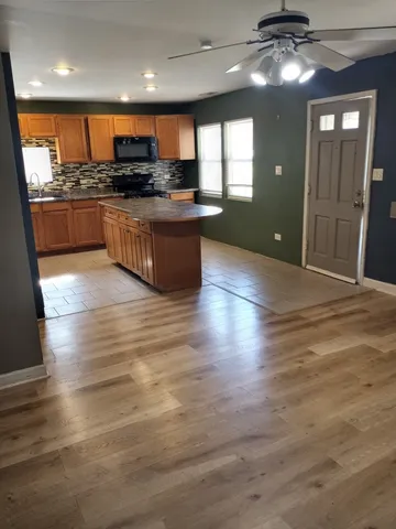 a kitchen with stainless steel appliances granite countertop a stove and cabinets