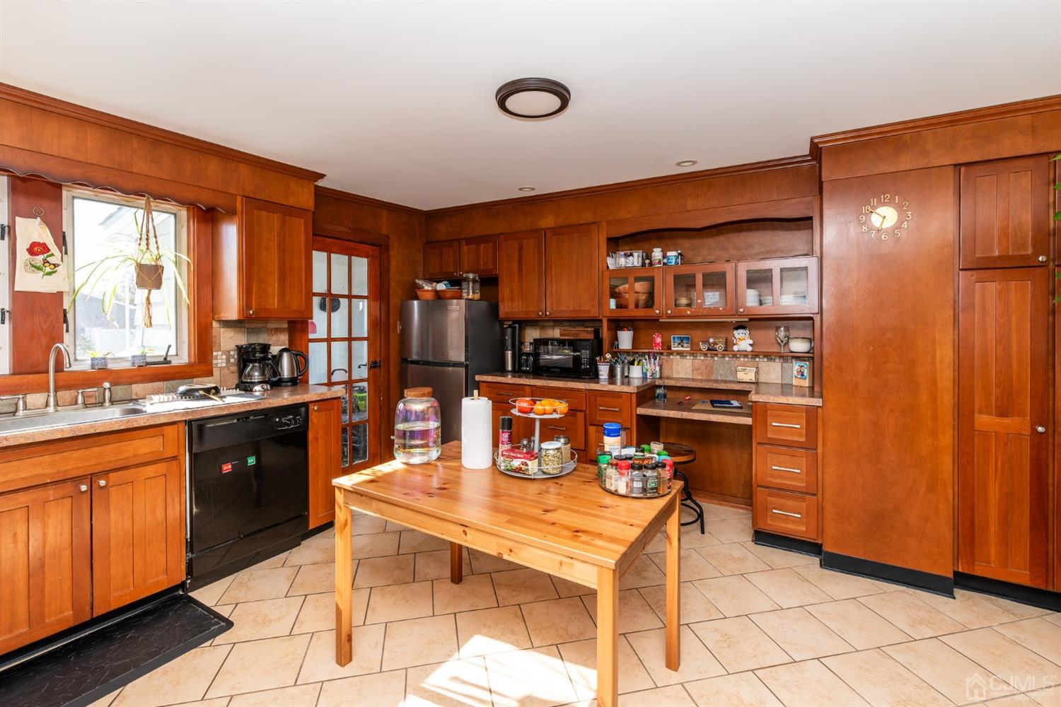 56 Half Acre Road Jamesburg, NJ 08831 - Photo 12 of 31 a kitchen with stainless steel appliances kitchen island granite countertop a table chairs and a refrigerator