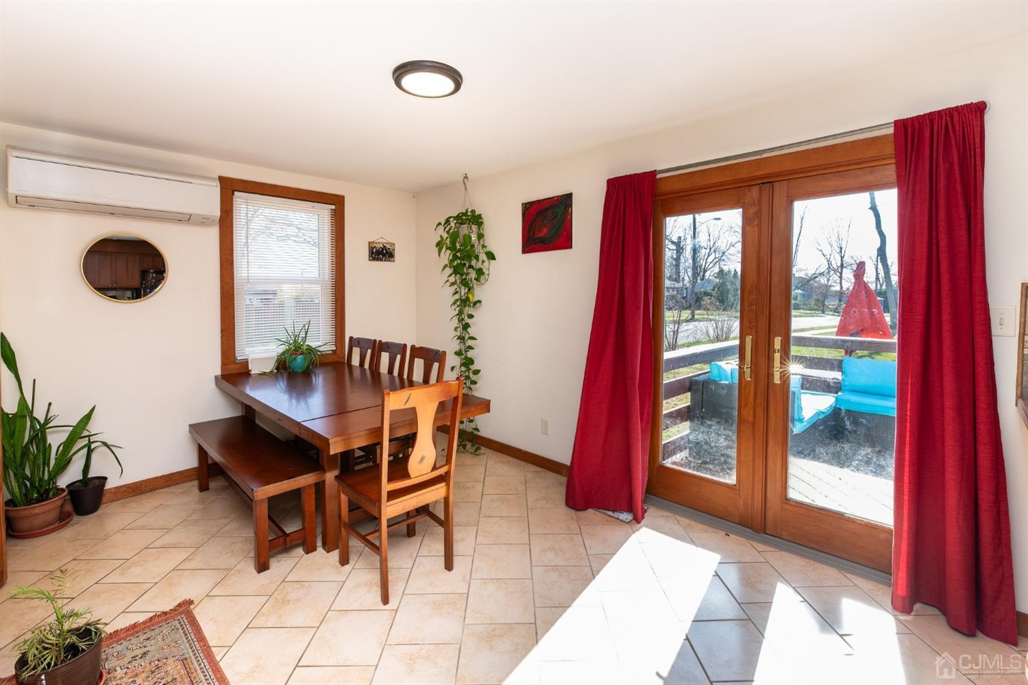 56 Half Acre Road Jamesburg, NJ 08831 - Photo 16 of 31 a dining room with furniture and a floor to ceiling window