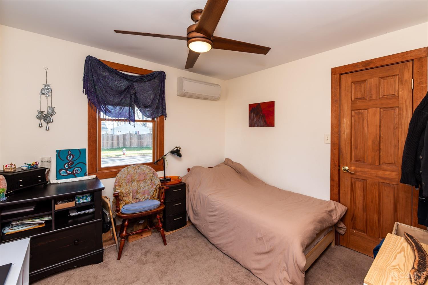 56 Half Acre Road Jamesburg, NJ 08831 - Photo 21 of 31 a bed room with a bed and a chair