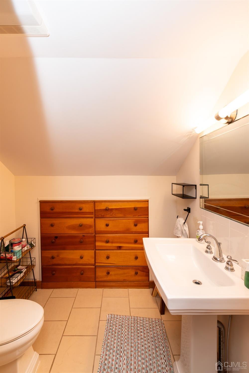 56 Half Acre Road Jamesburg, NJ 08831 - Photo 27 of 31 a view of a bathroom with a sink and a mirror