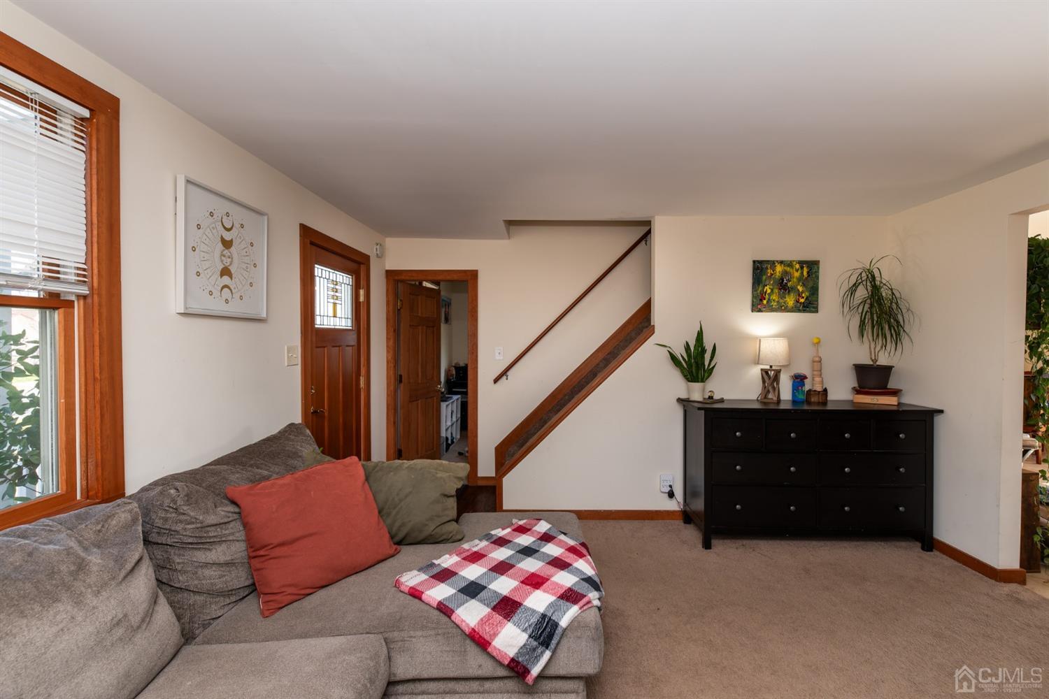 56 Half Acre Road Jamesburg, NJ 08831 - Photo 9 of 31 a living room with furniture and stairs