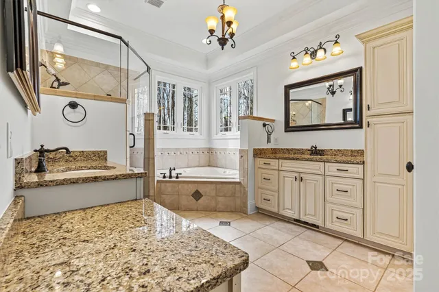 a spacious bathroom with a granite countertop sink and a mirror