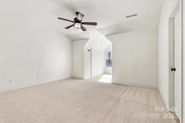 a view of room with ceiling fan and window