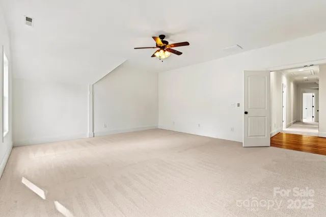 an empty room with closet and windows