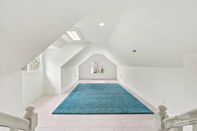 a bathroom with a granite countertop sink and cabinets