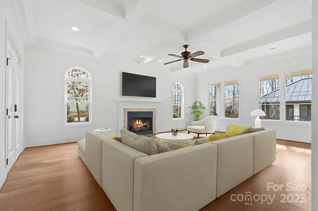 a living room with furniture a fireplace and a flat screen tv