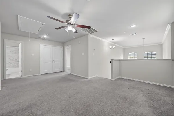 a view of an empty room with a ceiling fan