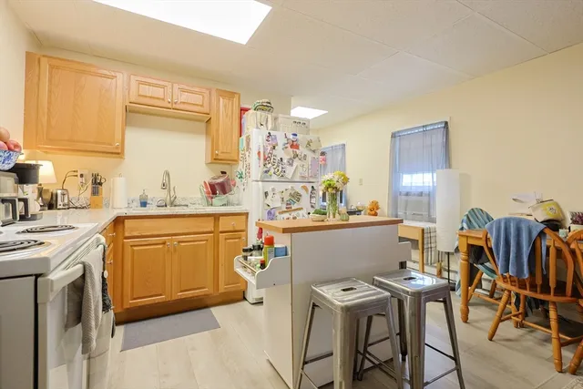 a kitchen with a table chairs and a refrigerator