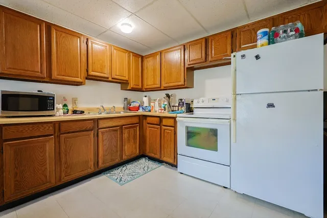 a kitchen with stainless steel appliances granite countertop a refrigerator sink and cabinets