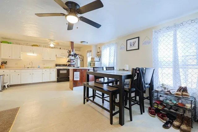 a view of a dining room with furniture and a window
