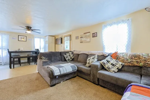 a living room with furniture and a piano