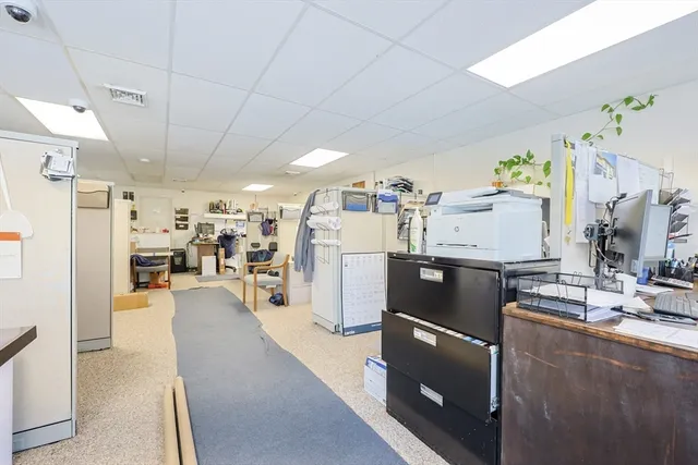 a view of a kitchen with furniture and a refrigerator
