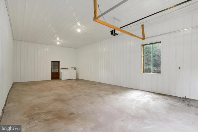 a view of a big room with wooden floor and windows