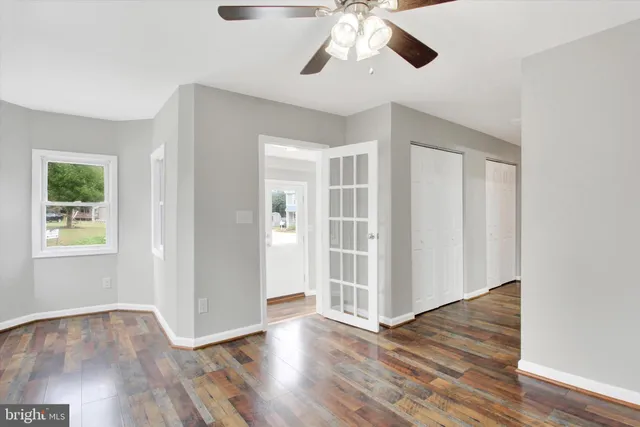 wooden floor in an empty room with a window