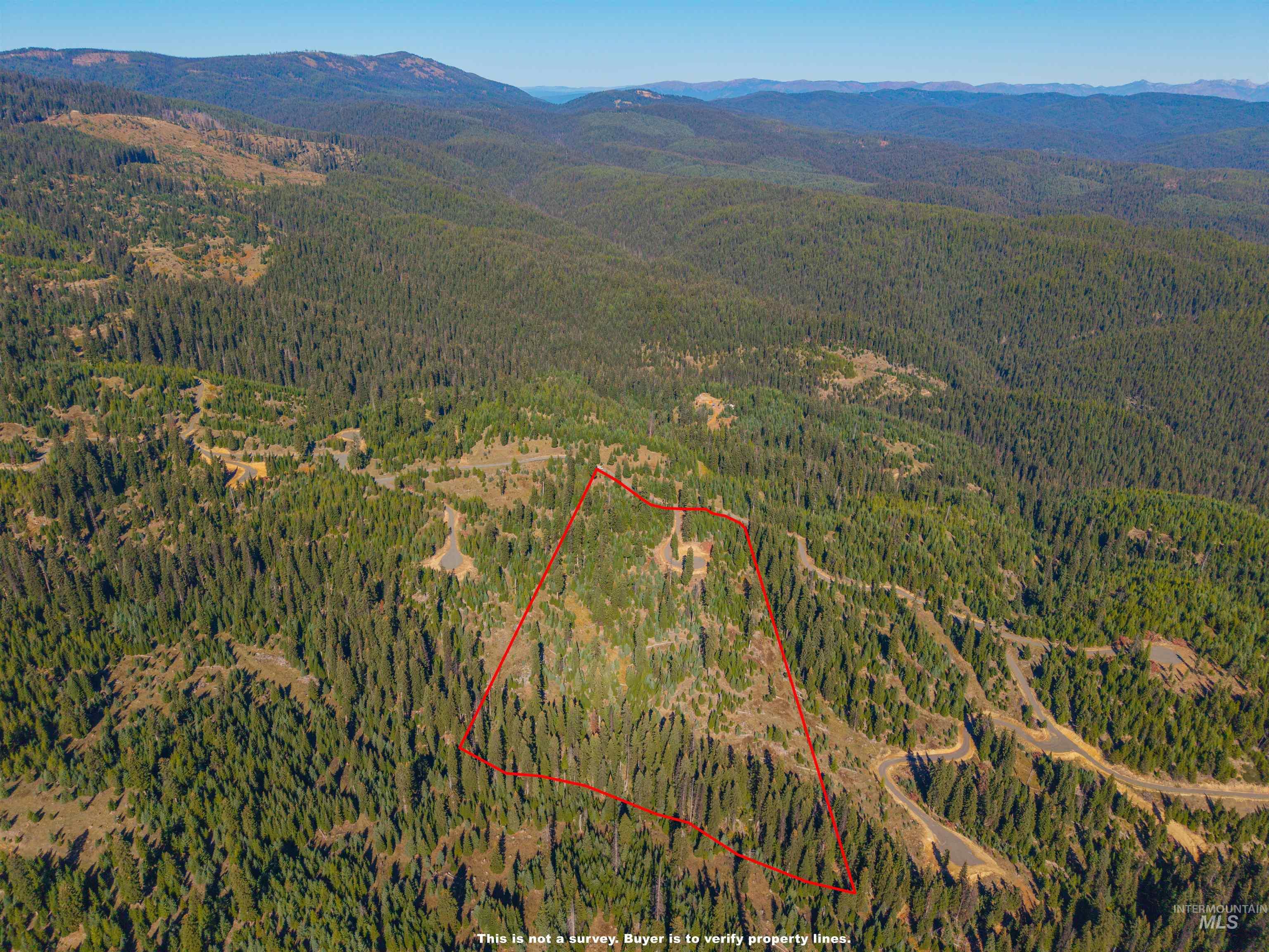 4 Tree Farm Trails Road Elk City, ID 83525 - Photo 1 of 17 Aerial overview of property's location featuring property parcel outlined and a mountain backdrop