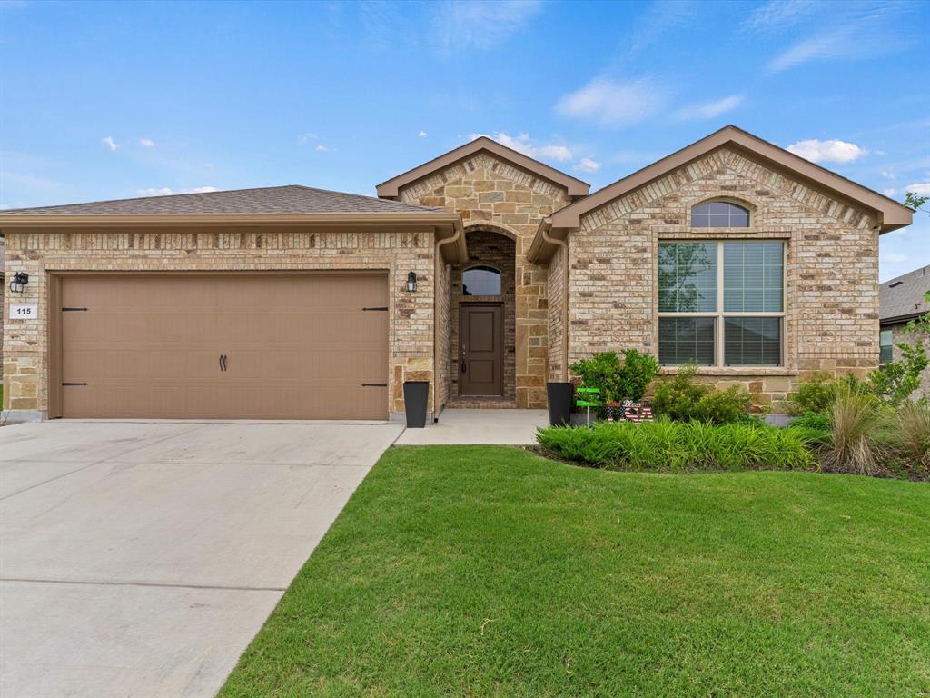 115 Willow Street Rhome, TX 76078 - Photo 1 of 1 View of front facade with a garage and a front lawn