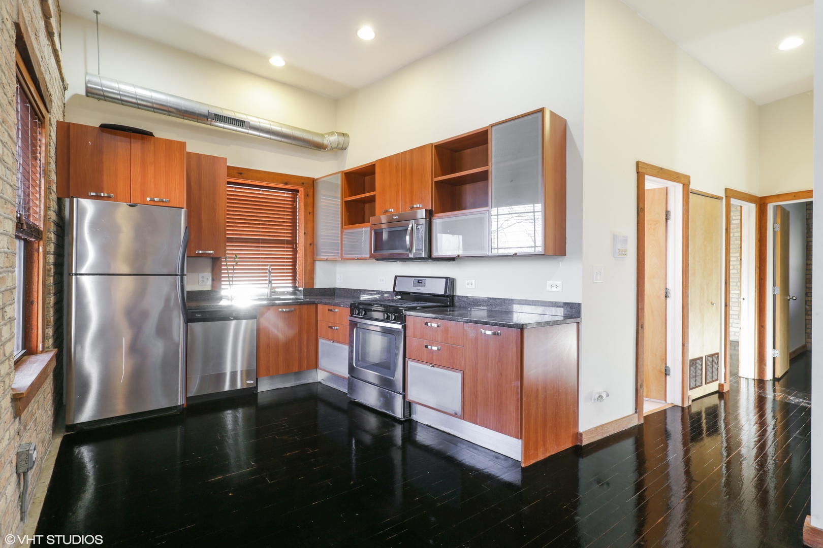 1701 West Greenleaf Avenue, Unit 3 Chicago, IL 60626 - Photo 4 of 10 a kitchen with stainless steel appliances granite countertop a refrigerator a stove and a sink with wooden floor