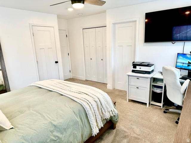 7818 North Windhover Road Eagle Mountain, UT 84005 - Photo 13 of 32 Carpeted room featuring a ceiling fan with integrated lighting, white shaker-style doors, and bi-fold closet doors