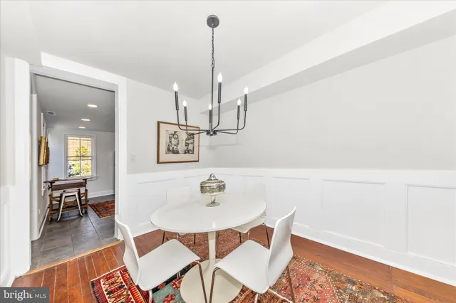 a dining room with furniture and wooden floor