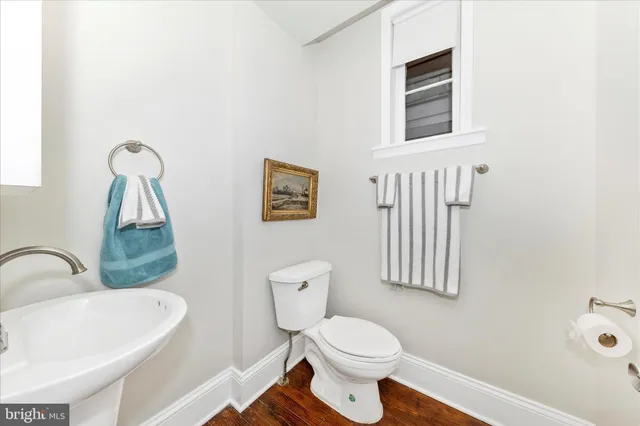 a white toilet sitting next to a bathroom sink
