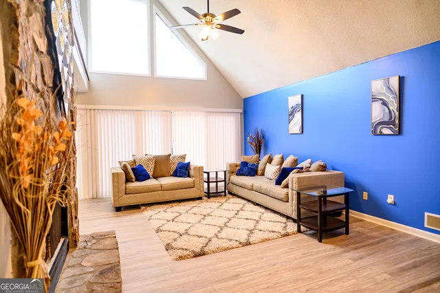a living room with furniture and a wooden floor