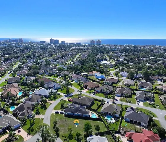 an aerial view of residential houses with city view