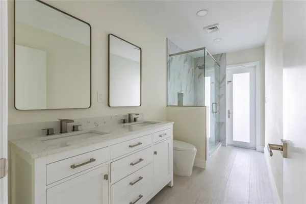 a view of a bathroom from a hallway