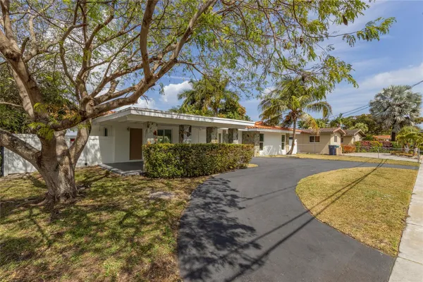 a view of a house with snow on the tree