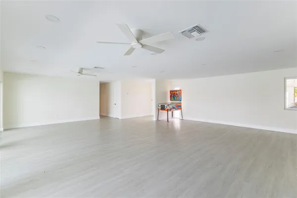 a kitchen with stainless steel appliances granite countertop a refrigerator and wooden cabinets