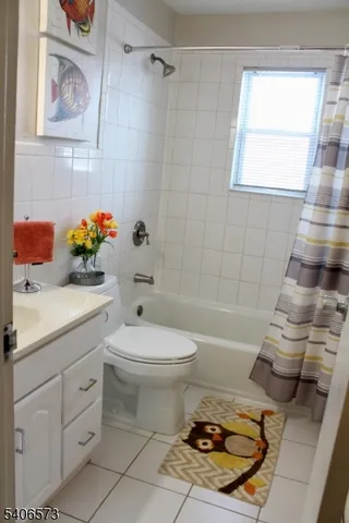 a bathroom with a sink toilet vanity and bathtub