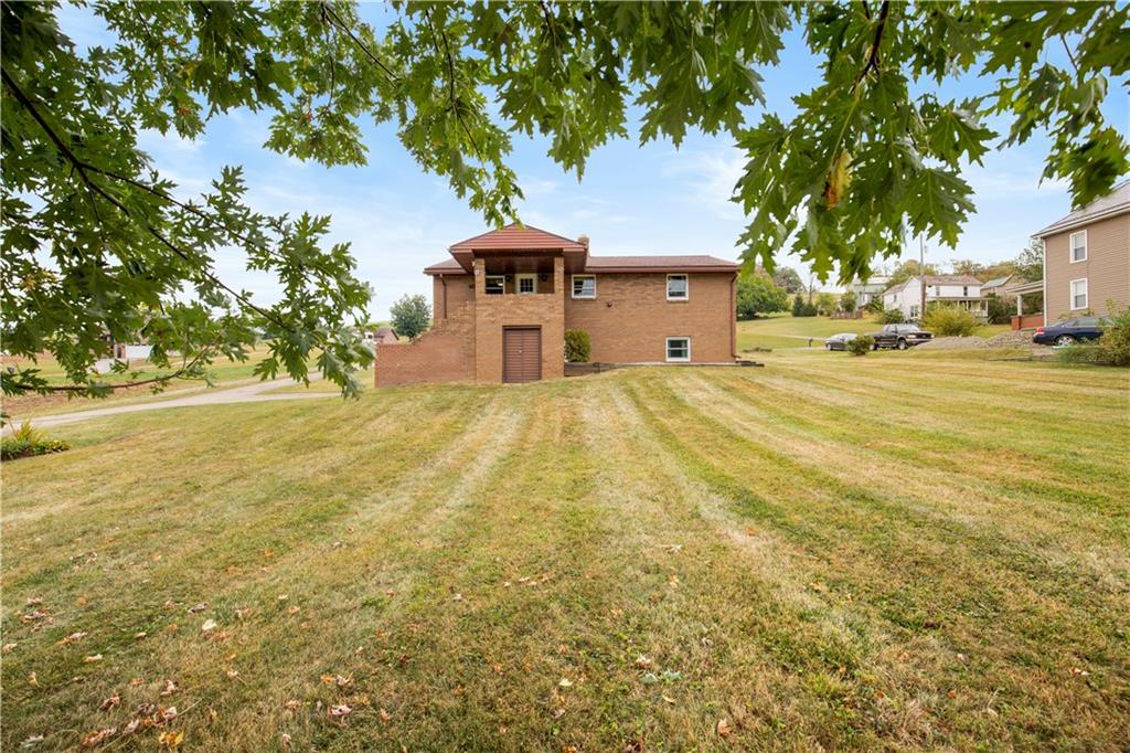 222 McConnell Road Mount Pleasant, PA 15666 - Photo 6 of 37 a house with trees in front of it