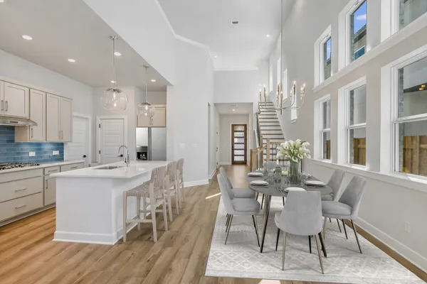 a view of a dining room with furniture and wooden floor