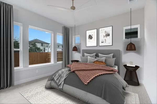 a bedroom with a bed and a large window