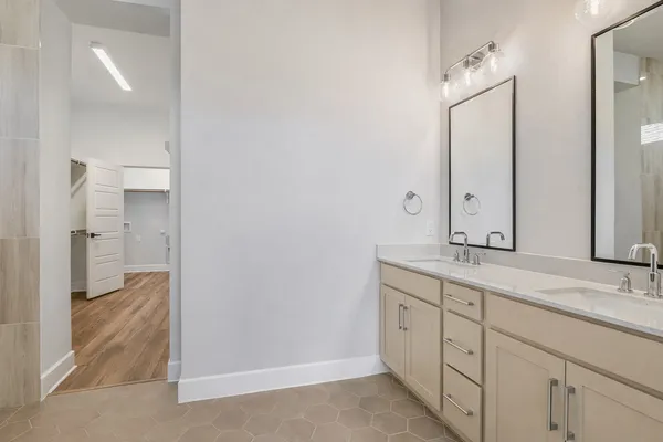 a spacious bathroom with a granite countertop sink mirror and double