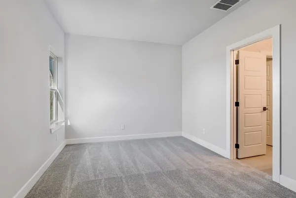 an empty room with a empty space and a window