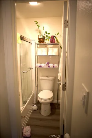 a bathroom with a toilet and a shower curtain