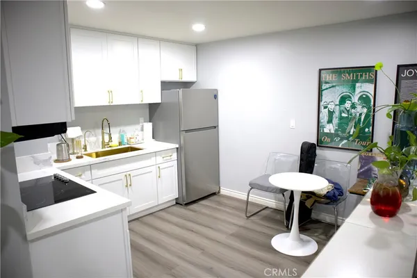 a kitchen with a sink cabinets and wooden floor