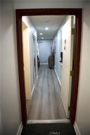 a view of hallway with wooden floor