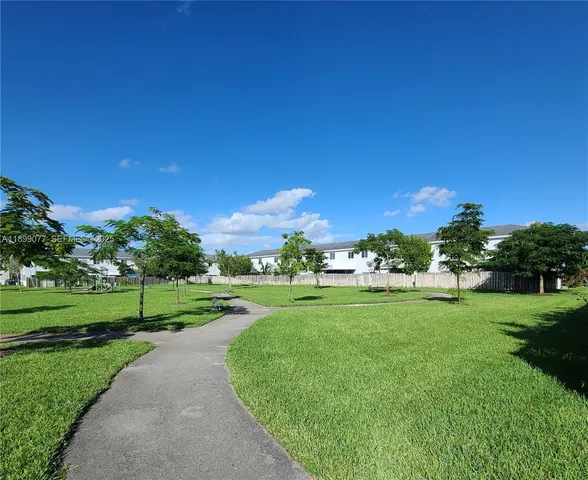 a view of grassy field with grass and trees